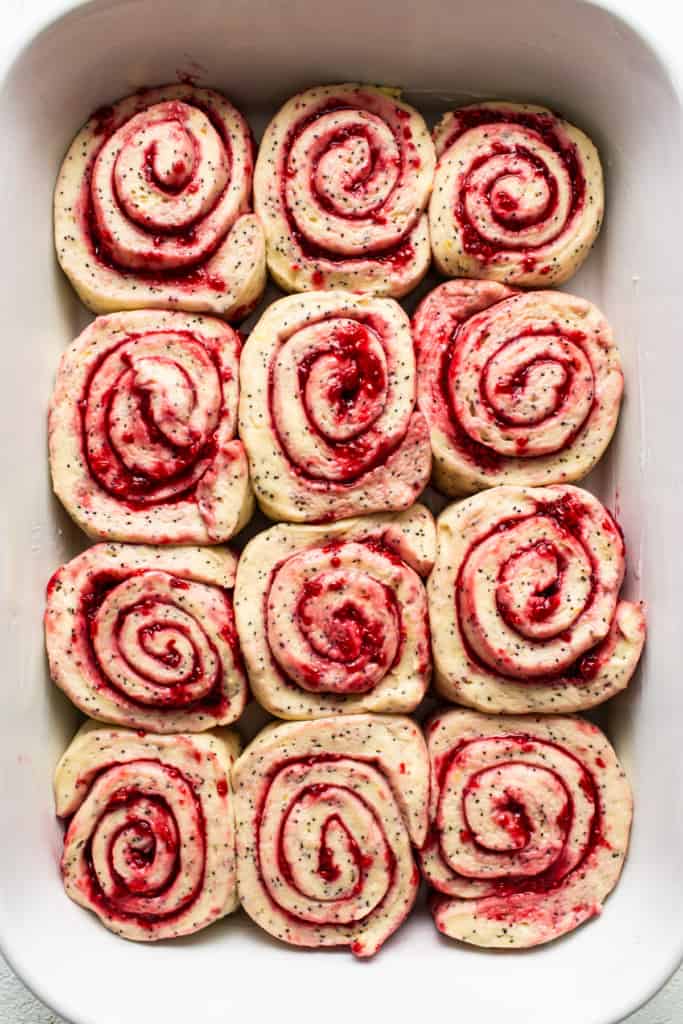 Raspberry roll ups in a white dish.