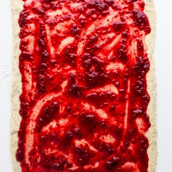 A square of dough with raspberry jam on it.