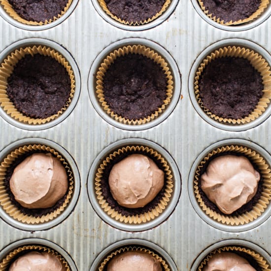 Chocolate cupcakes in a muffin tin.