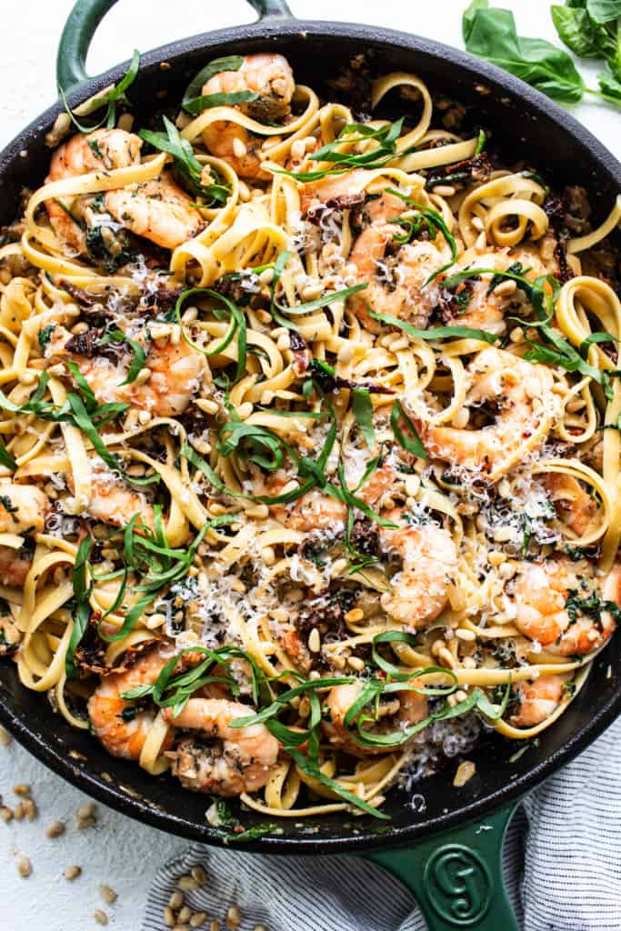 A skillet filled with pasta and shrimp.