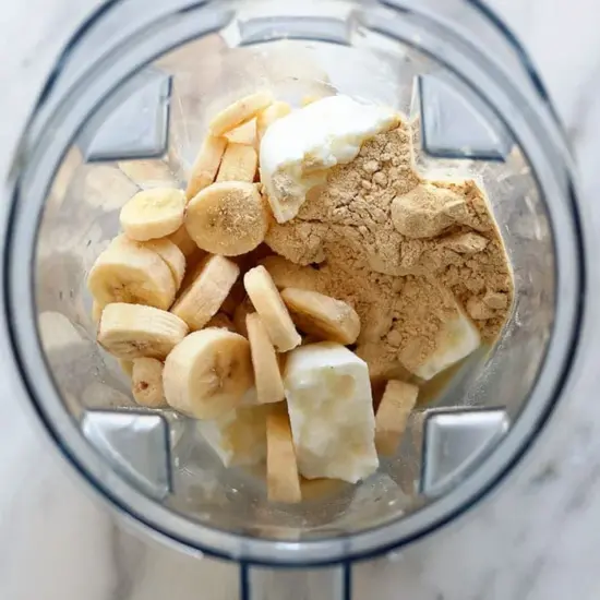 A blender filled with bananas and other ingredients, creating a delicious banana protein shake.
