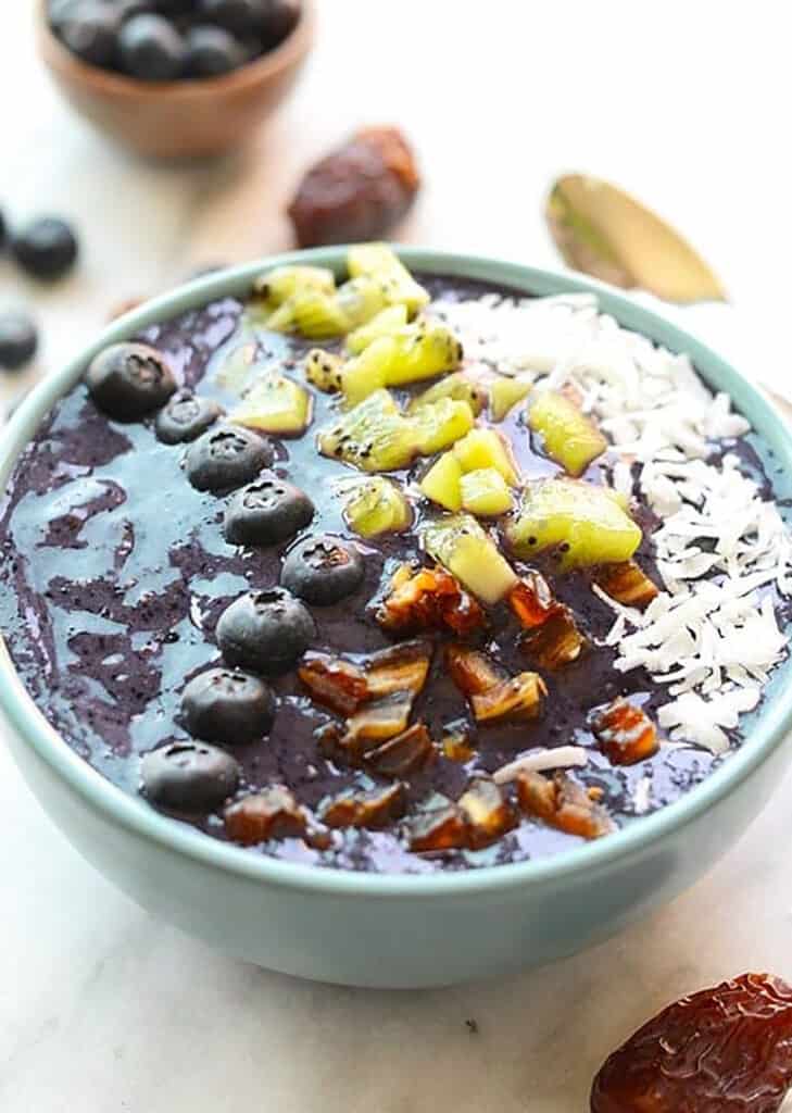 A delicious Blueberry Smoothie Bowl topped with kiwi and granola.