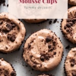 A group of chocolate cupcakes with chocolate crumbs.