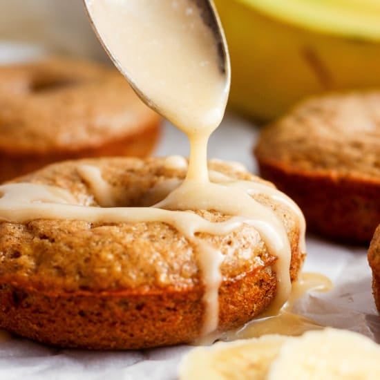 Drizzling icing onto freshly baked banana muffins.