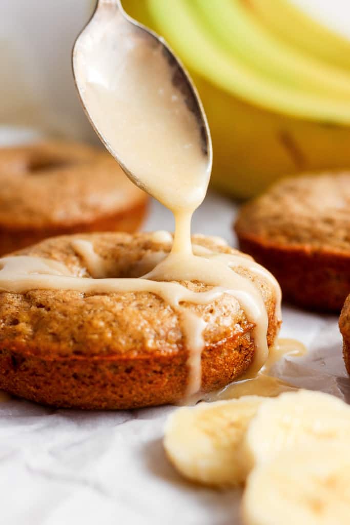 Drizzling icing onto freshly baked banana muffins.