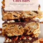 Stack of peanut butter chex bars with visible layers and scattered peanuts around, promoted as a healthy dessert recipe.