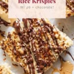 Close-up of toasted rice krispies squares topped with peanut butter and chocolate drizzle, arranged neatly on parchment paper.