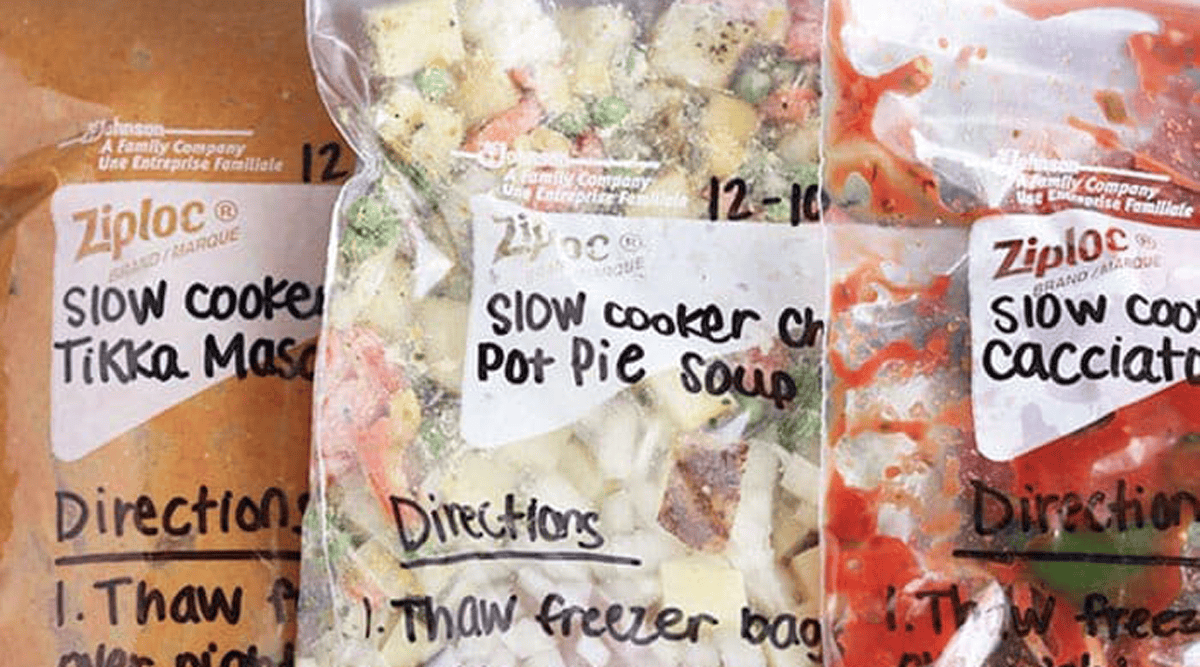 Three Ziploc bags labeled "Slow Cooker Tikka Masala," "Slow Cooker Chicken Pot Pie Soup," and "Slow Cooker Cacciatora" with visible instructions written on each.