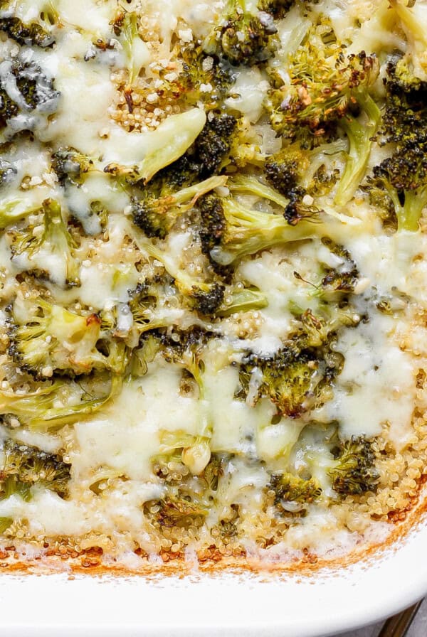 Broccoli and cheese casserole in a white baking dish with a golden crust.