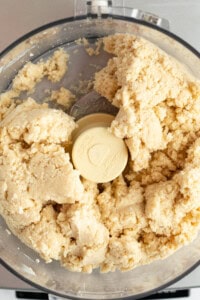 Close-up of dough being mixed in a food processor.