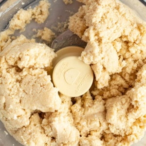 Close-up of dough being mixed in a food processor.