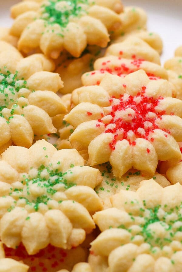 A plate of star-shaped cookies with red and green sprinkles.