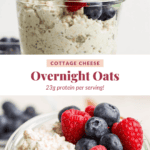 A glass jar brimming with cottage cheese overnight oats is topped with fresh blueberries and raspberries, as honey cascades over the mix. Text overlay: "Cottage Cheese Overnight Oats, packing 23g of protein per serving!.