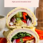 Cottage cheese protein wrap with turkey, spinach, red onion, cucumber, and bell peppers on a plate. Text reads: "Cottage Cheese Protein Wrap. High-protein breakfast idea!.