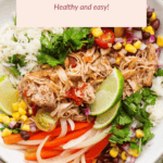 A bowl of chicken taco ingredients, including shredded chicken, rice, lime slices, corn, black beans, onions, red bell peppers, and cilantro. Text reads: "Crockpot Chicken Taco Bowls. Healthy and easy!.