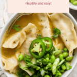 A bowl of wonton soup with lemon slices, edamame, sliced green chili, and cilantro garnish. Text above reads: "Lemon Wonton Soup - Healthy and easy!.