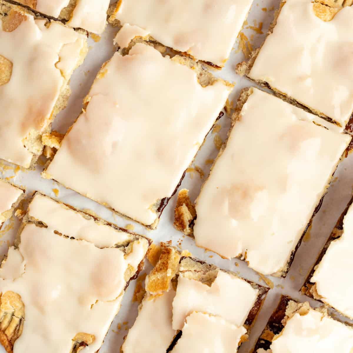 Top view of frosted protein pop tarts laid out in a grid pattern on a white surface.