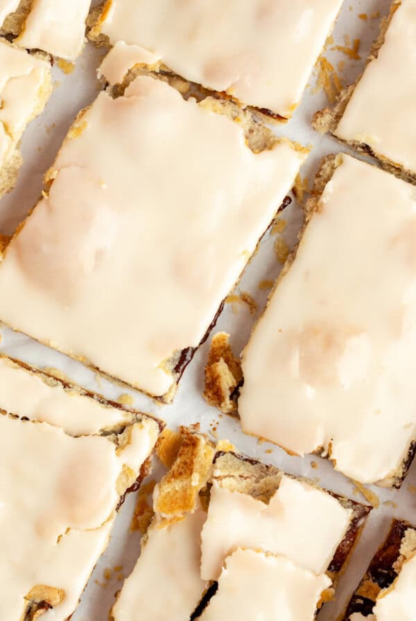 Top view of frosted protein pop tarts laid out in a grid pattern on a white surface.