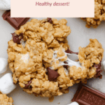 Close-up of peanut butter oatmeal s'more cookies with melted marshmallows and chocolate pieces, surrounded by marshmallows and chocolate squares. Label reads "PB Oatmeal S’more Cookies - Healthy dessert!".