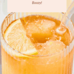A glass of blended Arnold Palmer cocktail with ice, a lemon wedge, and a straw. A label above reads "Blended Arnold Palmer Boozy!.