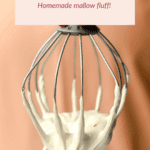 A metal whisk covered in white marshmallow fluff is held up in front of a peach-colored background. Text above reads: "Maple Marshmallow Fluff, Homemade mallow fluff!.