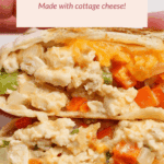 Close-up of a sliced buffalo chicken burrito filled with cottage cheese, diced vegetables, and melted cheese. A label above describes it as high-protein and made with cottage cheese.