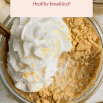 A glass jar of pumpkin chia pudding topped with whipped cream and crumbled cookie, labeled as a healthy breakfast.